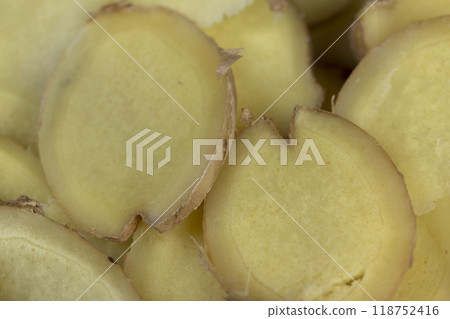 details of the ginger root used in cooking sliced into pieces details of the ginger root used in cooking sliced into pieces 118752416