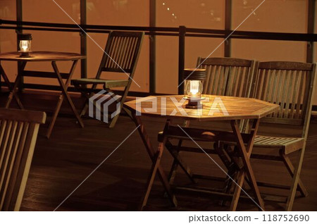 Wooden table, chairs and lamps outside 118752690