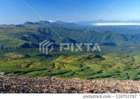 Climbing Mount Asahidake, one of the 100 famous mountains in Japan - View of autumn foliage in the direction of Mount Tokachi from the Asahidake hiking trail in the Daisetsuzan mountains Climbing Mount Asahidake, one of the 100 famous mountains in Japan - View of autumn foliage in the direction of Mount Tokachi from the Asahidake hiking trail in the Daisetsuzan mountains 118752787