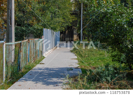 The sidewalk is paved with stone. Odessa Cheremushki. The pedestrian path is paved with paving stones. 118753878