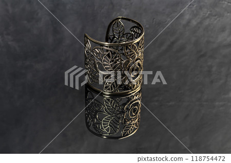 Bracelets. Women's jewelry on a dark background. Metal products. Fashion. Bracelets. Women's jewelry on a dark background. Metal products. Fashion. 118754472