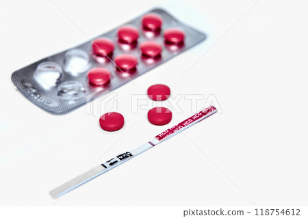 Menstruation or birth control concept. Close-up notepad and test pack with negative result. Menstruation or birth control concept. Close-up notepad and test pack with negative result. 118754612