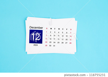 December Calendar 2024 page on blue background. 118755231
