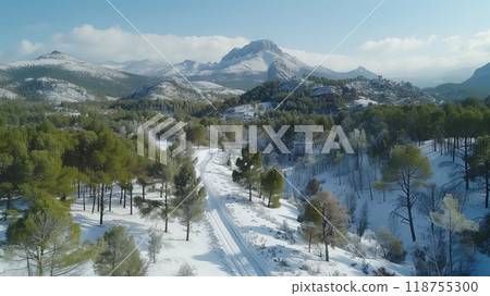 Snow-covered Mountain Landscape With a Winding Road Through the Forest in Winter 118755300