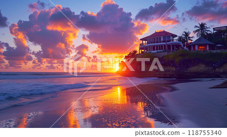 Stunning Sunset View Over the Beach With Clouds Reflecting in the Water Near a Coastal Villa 118755340