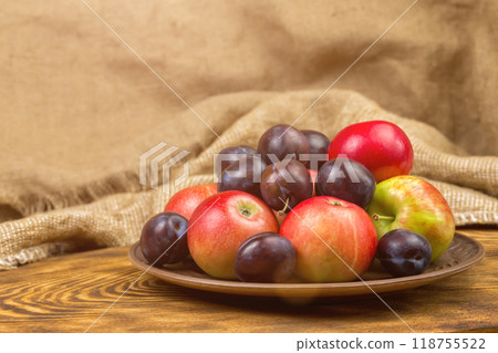 fruits, apples and plums on a plate fruits, apples and plums on a plate 118755522