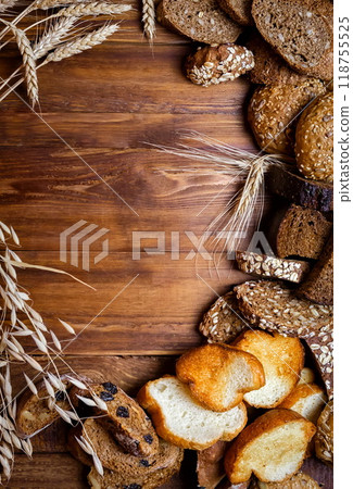 Assortment of baked bread on wooden table background Assortment of baked bread on wooden table background 118755525