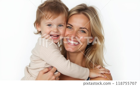 A cheerful mother with blonde hair hugs her smiling baby, showcasing love and affection between mother and child. 118755707