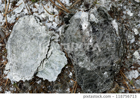 Macro photography of unprocessed pieces of mica minerals in a natural deposit. 118756713