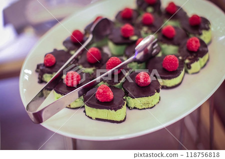 Beautiful multicolored decorated baked sweet tasty party cakes or catering cakes for party, bar dessert selection with cake, pie and pastries catering banquet, coffee break buffet at a conference 118756818
