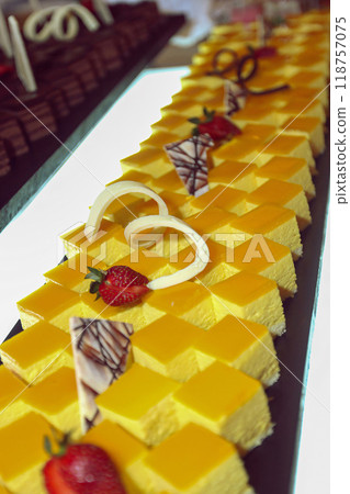 Beautiful multicolored decorated baked sweet tasty party cakes or catering cakes for party, bar dessert selection with cake, pie and pastries catering banquet, coffee break buffet at a conference 118757075