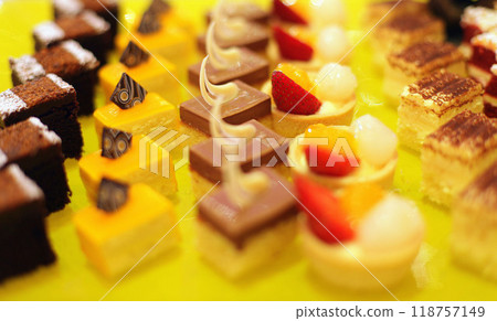 Beautiful multicolored decorated baked sweet tasty party cakes or catering cakes for party, bar dessert selection with cake, pie and pastries catering banquet, coffee break buffet at a conference 118757149