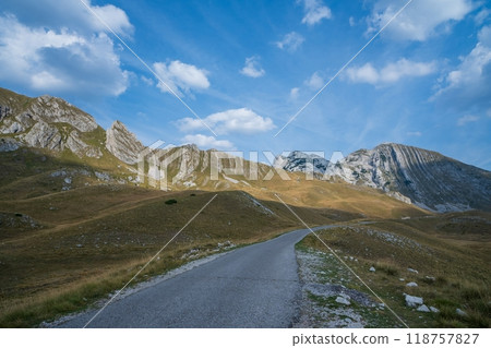 Mountain road winding through rocky peaks and hills. Durmitor National Park. Montenegro Mountain road winding through rocky peaks and hills. Durmitor National Park. Montenegro 118757827