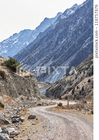 Journey to the mountains. Winding road, high rocky mountains with steep slopes 118757876