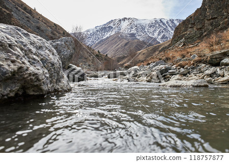 Calm water flow in a mountain river 118757877