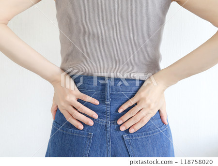 Woman holding her waist, lower back pain 118758020