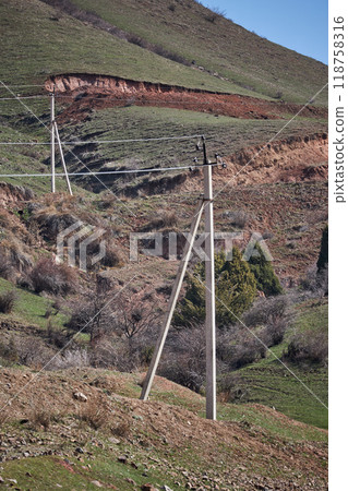 Two concrete pillar, old power line, low household voltage levels, countryside 118758316