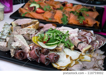 Closeup of pork and salmon assortiment at the party buffet Closeup of pork and salmon assortiment at the party buffet 118759002