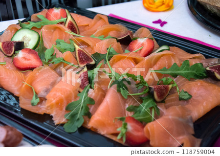 Closeup of sliced salmon in a black plate at the party buffet 118759004
