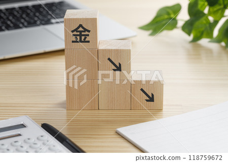 A building block with a gold down arrow on it 118759672