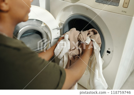 Loading Laundry in Washing Machine at Home 118759746