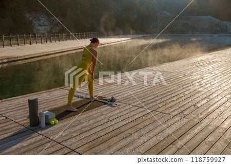 Engaging in a Morning Yoga Practice by the Calm Water Creates a Refreshing Start to the Day 118759927