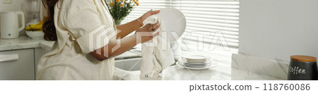 Cleaning Dishes in Modern Kitchen With Natural Light Coming In Cleaning Dishes in Modern Kitchen With Natural Light Coming In 118760086