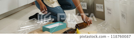 Collecting Plastic Bottles in Kitchen for Recycling 118760087