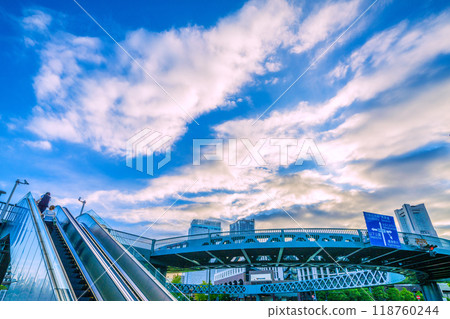 Yokohama cityscape in Japan. Shinko Circle Walk and escalators. Yokohama Landmark Tower in the far right. 118760244