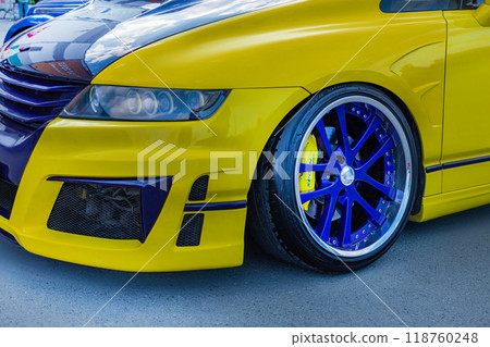 15.09.2024. Novosibirsk, Midday, close up photo of yellow stance Honda Odyssey with big blue rims, cast disc 15.09.2024. Novosibirsk, Midday, close up photo of yellow stance Honda Odyssey with big blue rims, cast disc 118760248