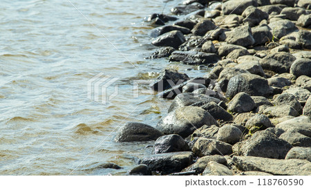 Rocky bank of a large river on a sunny day Rocky bank of a large river on a sunny day 118760590
