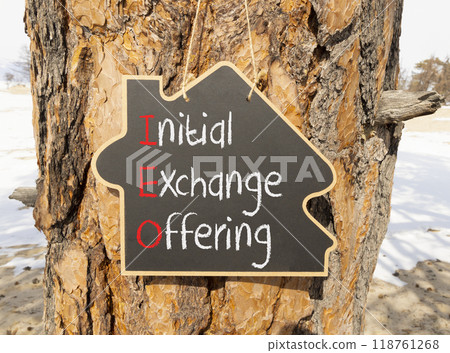 IEO initial exchange offering symbol. Concept words IEO initial exchange offering on beautiful yellow blackboard. Beautiful tree background. Business IEO initial exchange offering concept. Copy space 118761268