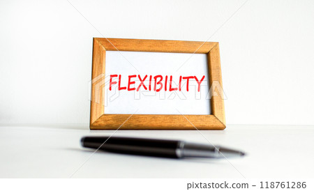 Flexibility symbol. Concept word Flexibility on beautiful wooden picture frame. Beautiful white background. Black pen. Business flexibility concept. Copy space. 118761286