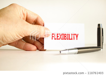 Flexibility symbol. Concept word Flexibility on beautiful white card. Beautiful wooden background. Businessman hand. Beautiful black pen. Business flexibility concept. Copy space. 118761403