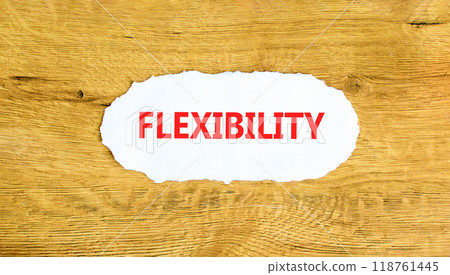 Flexibility symbol. Concept word Flexibility on beautiful white paper. Beautiful wooden wall background. Business flexibility concept. Copy space. Flexibility symbol. Concept word Flexibility on beautiful white paper. Beautiful wooden wall background. Business flexibility concept. Copy space. 118761445