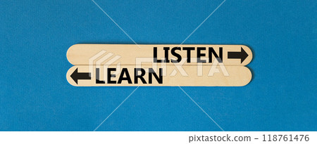Listen and learn symbol. Concept word Listen and Learn on beautiful wooden stick. Beautiful blue table blue background. Business and listen and learn concept. Copy space. 118761476