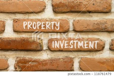Property investment symbol. Concept words Property investment on beautiful brick wall. Beautiful red brown brick wall background. Business Property investment concept. Copy space. 118761479