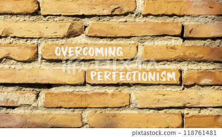 Overcoming perfectionism symbol. Concept words Overcoming perfectionism on beautiful brick wall. Beautiful red brown brick wall background. Business Overcoming perfectionism concept. Copy space. Overcoming perfectionism symbol. Concept words Overcoming perfectionism on beautiful brick wall. Beautiful red brown brick wall background. Business Overcoming perfectionism concept. Copy space. 118761481