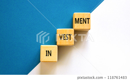 Investment symbol. Concept word Investment on beautiful wooden blocks. Beautiful white and blue background. Business investment concept. Copy space. 118761483
