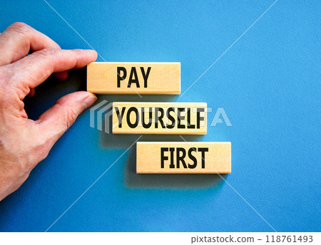 Pay yourself first symbol. Concept words Pay yourself first on beautiful wooden blocks. Beautiful blue table blue background. Businessman hand. Business and pay yourself first concept. Copy space. Pay yourself first symbol. Concept words Pay yourself first on beautiful wooden blocks. Beautiful blue table blue background. Businessman hand. Business and pay yourself first concept. Copy space. 118761493