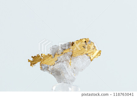 macro mineral stone metal gold in quartz on a white background 118763041