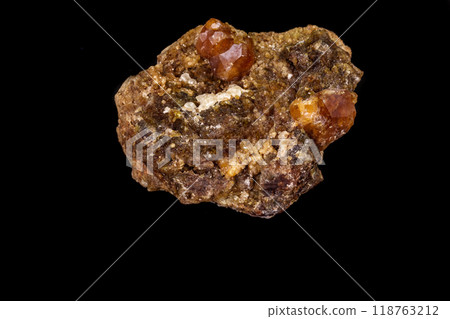 macro mineral stone Grossular, Garnet, Epidote on a black background 118763212