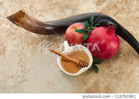 Rosh Hashanah. Jewish New Year composition with shofar, honey, apple, and pomegranate. 118763961