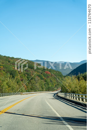 A winding road with view of mountains in White Mountain National Forest. 118764670
