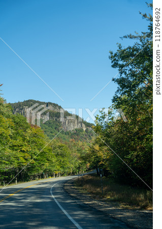 A winding road with view of mountains in White Mountain National Forest. A winding road with view of mountains in White Mountain National Forest. 118764692