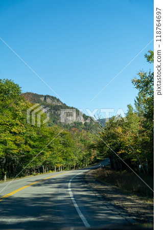 A winding road with view of mountains in White Mountain National Forest. A winding road with view of mountains in White Mountain National Forest. 118764697