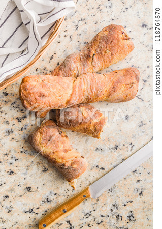 Crusty rustic baguette on kitchen table. Top view. Crusty rustic baguette on kitchen table. Top view. 118764870