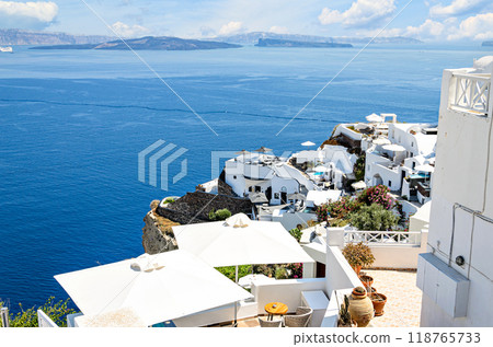 Oia, Santorini, views of the white houses with their cobbled streets. Village bathed by the South Aegean Sea, in the Cyclades, Greece Oia, Santorini, views of the white houses with their cobbled streets. Village bathed by the South Aegean Sea, in the Cyclades, Greece 118765733