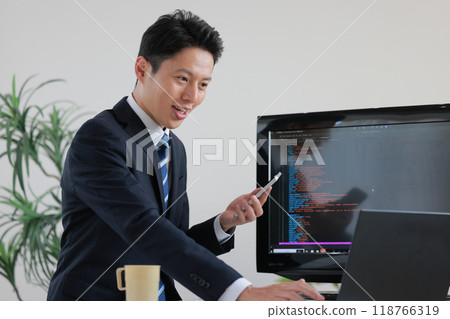 Engineer in a suit working on programming_1 Engineer in a suit working on programming_1 118766319