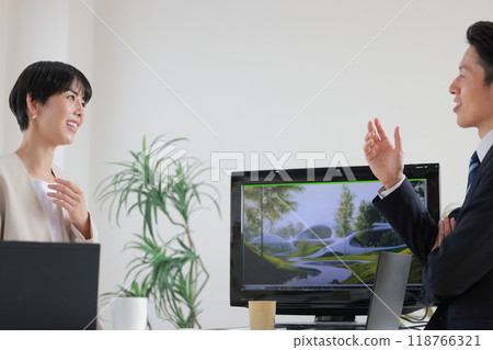 Designers discussing futuristic architectural design_1 Designers discussing futuristic architectural design_1 118766321